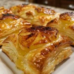 golden apple and brie puff pastry bites displayed on a serving platter.