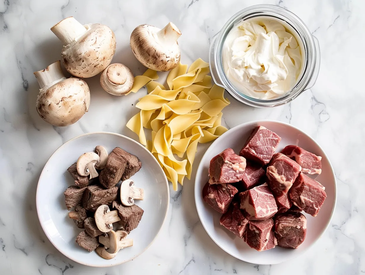 Ingredients for making slow cooker beef stroganoff including beef, soups, and spices